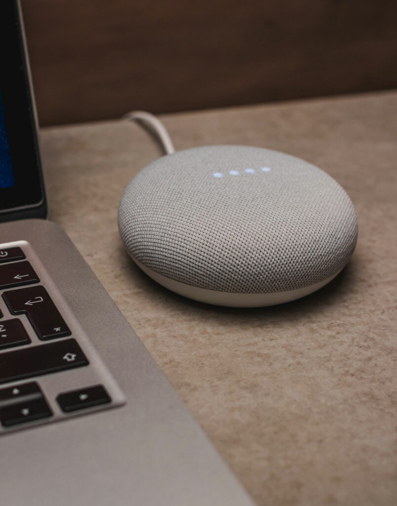 Nest mini activated next to a laptop